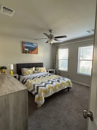 a bedroom with bed and window