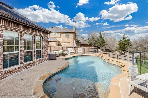 a view of a swimming pool with a lounge chair