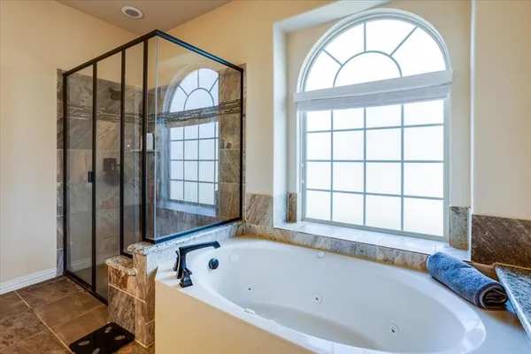 a bathroom with a bathtub and a window