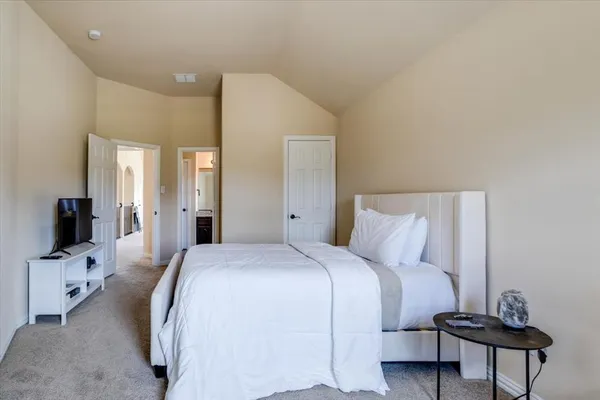 a bedroom with a bed and a tv on table