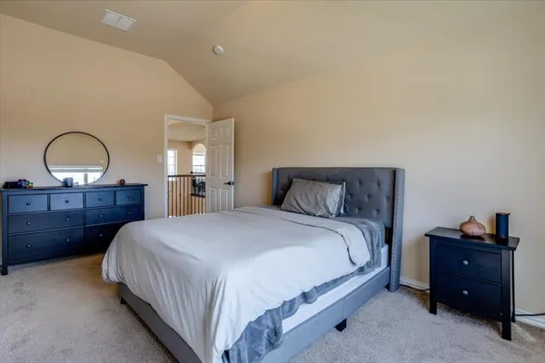 a bedroom with a bed and a dresser