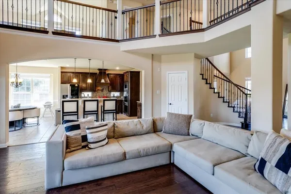 a living room with furniture a rug and a window