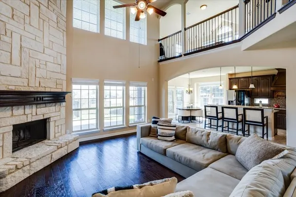 a living room with furniture fireplace and wooden floor