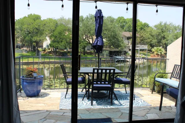 a view of sign board with yard and trees