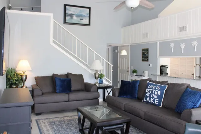 a living room with furniture and a chandelier
