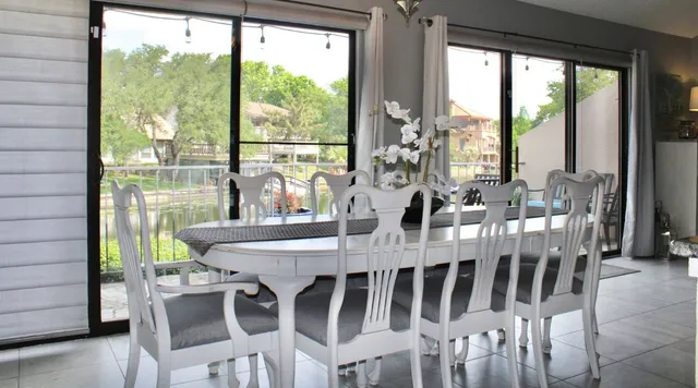 a view of a dining room with furniture window and outside view