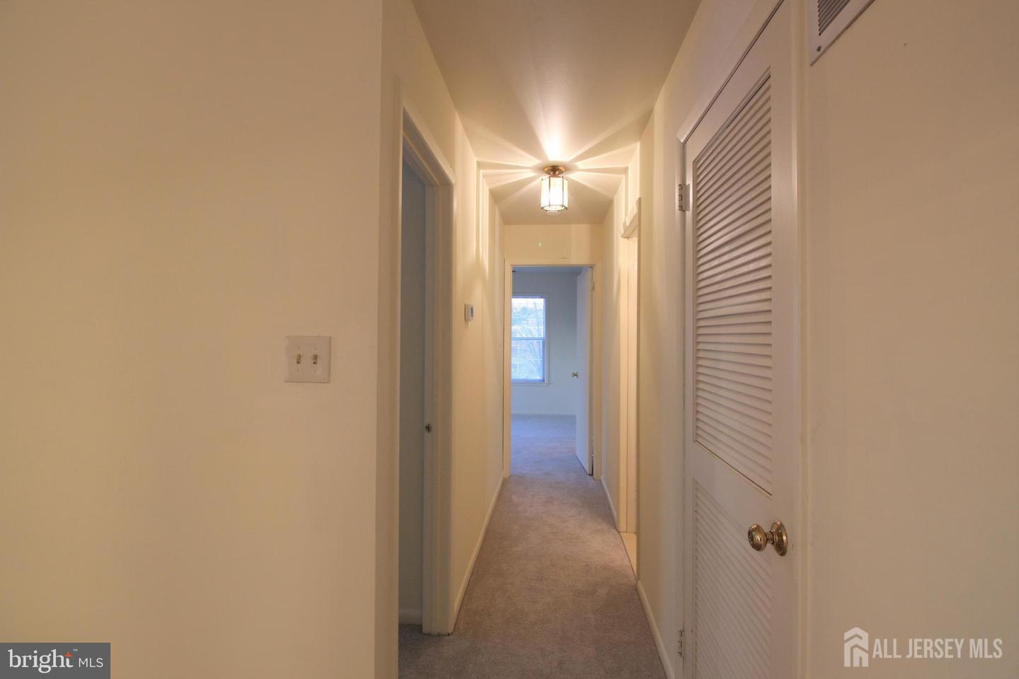 103 Claridge Court, Unit 5 Princeton, NJ 08540 - Photo 11 of 24 a view of a hallway with wooden floor