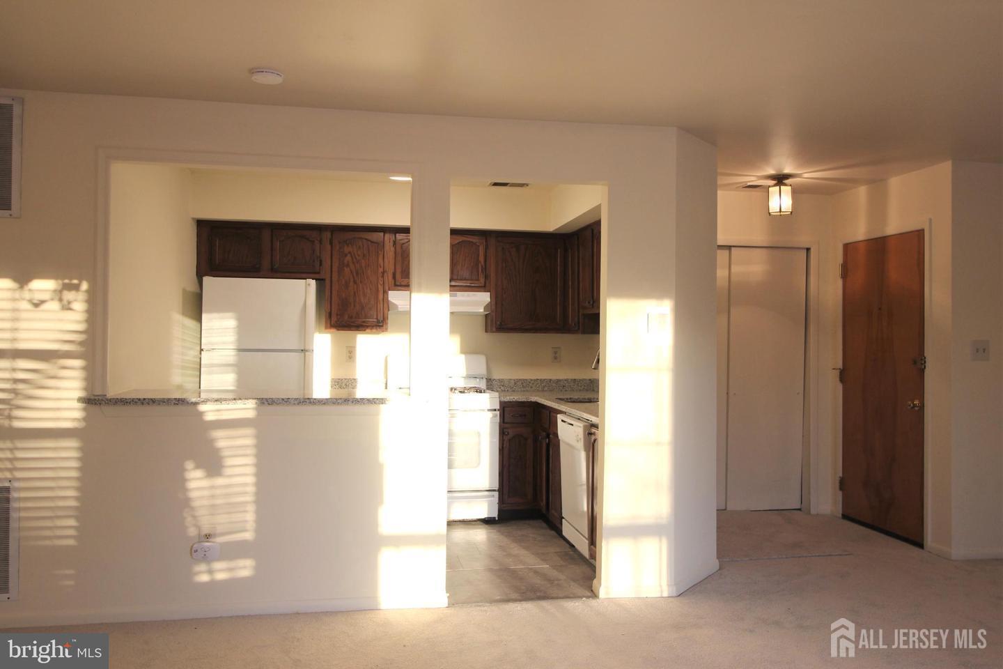 103 Claridge Court, Unit 5 Princeton, NJ 08540 - Photo 14 of 24 a kitchen with stainless steel appliances kitchen island granite countertop a refrigerator and a stove top oven