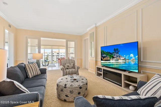 a living room with furniture a rug and a large window