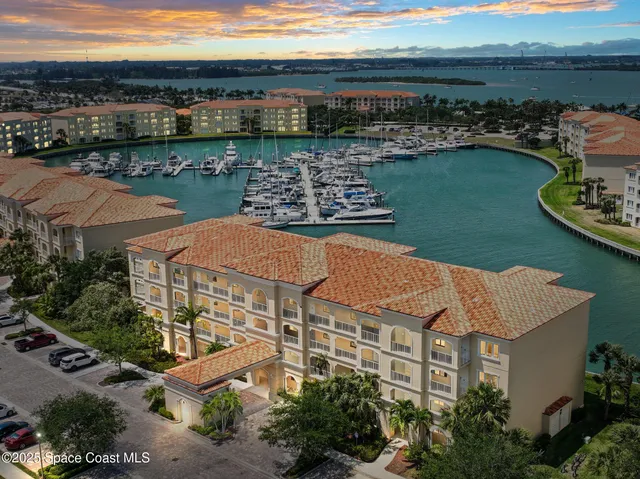 an aerial view of a house with a garden and lake view