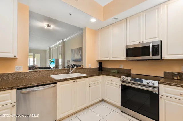 a kitchen with stainless steel appliances granite countertop a sink and a stove