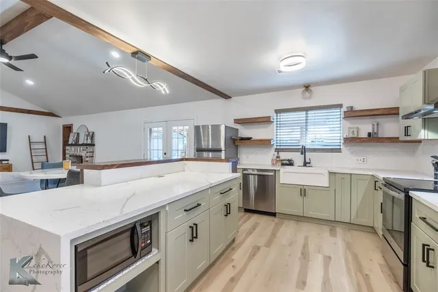 a kitchen with a stove a sink and a refrigerator