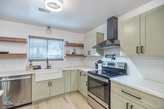 a kitchen with a sink stove and cabinets