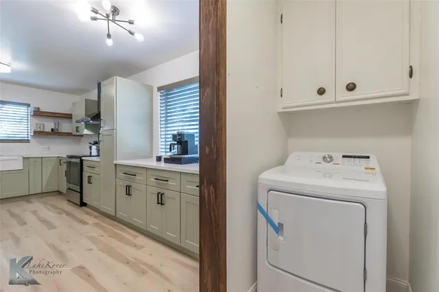 a utility room with closet dryer and washer