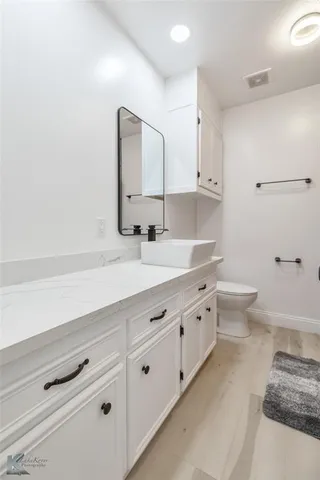 a spacious bathroom with double sink and a large mirror