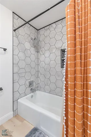 a bathroom with a bathtub and shower