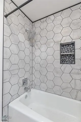 a bathroom with a white bathtub and a shower curtain