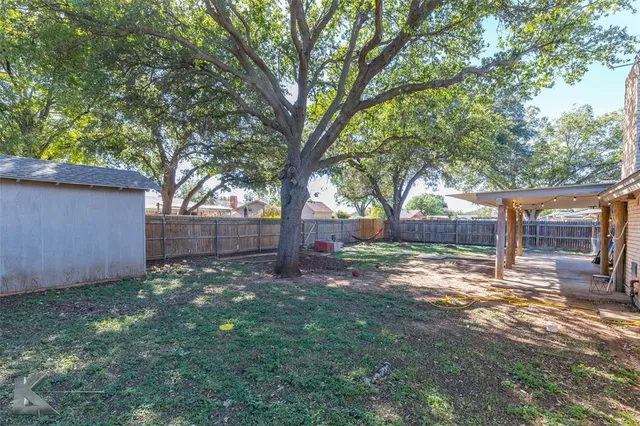 a backyard of a house with lots of green space