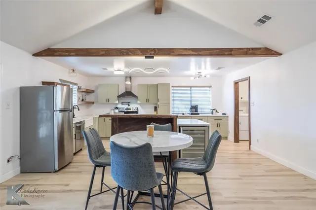 a dining room with furniture and window