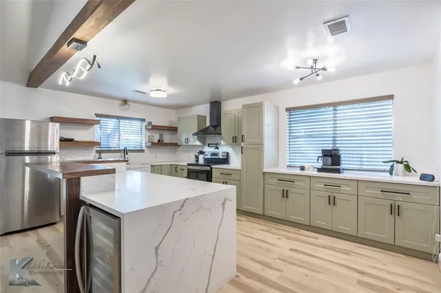 a kitchen with counter top space sink and stainless steel appliances