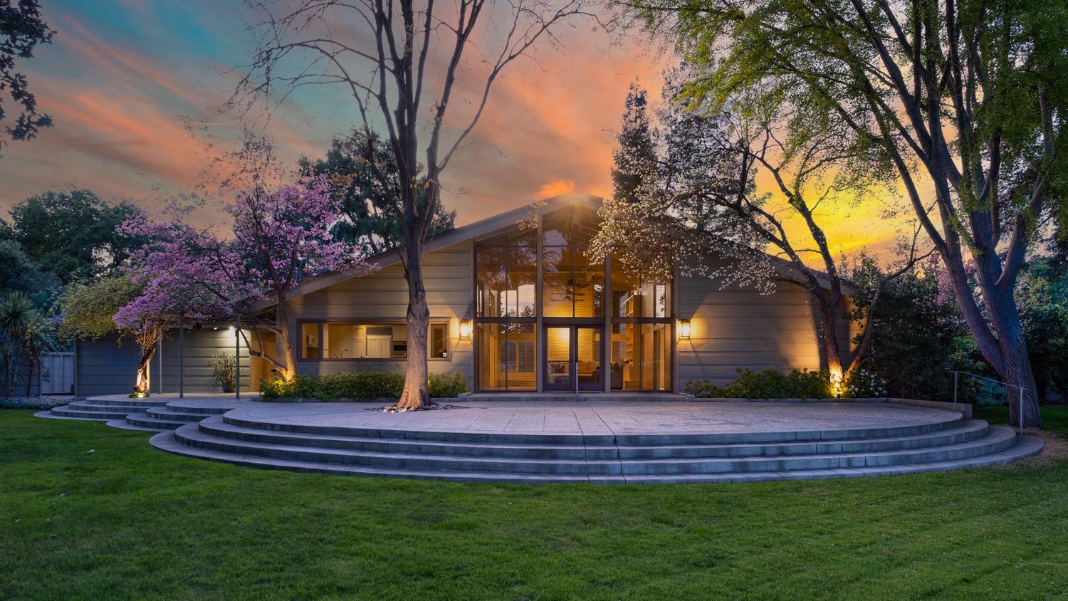 a front view of a house with a garden