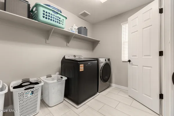 a bedroom with a bed and a computer