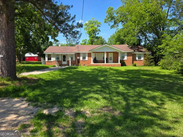 a front view of a house with a garden