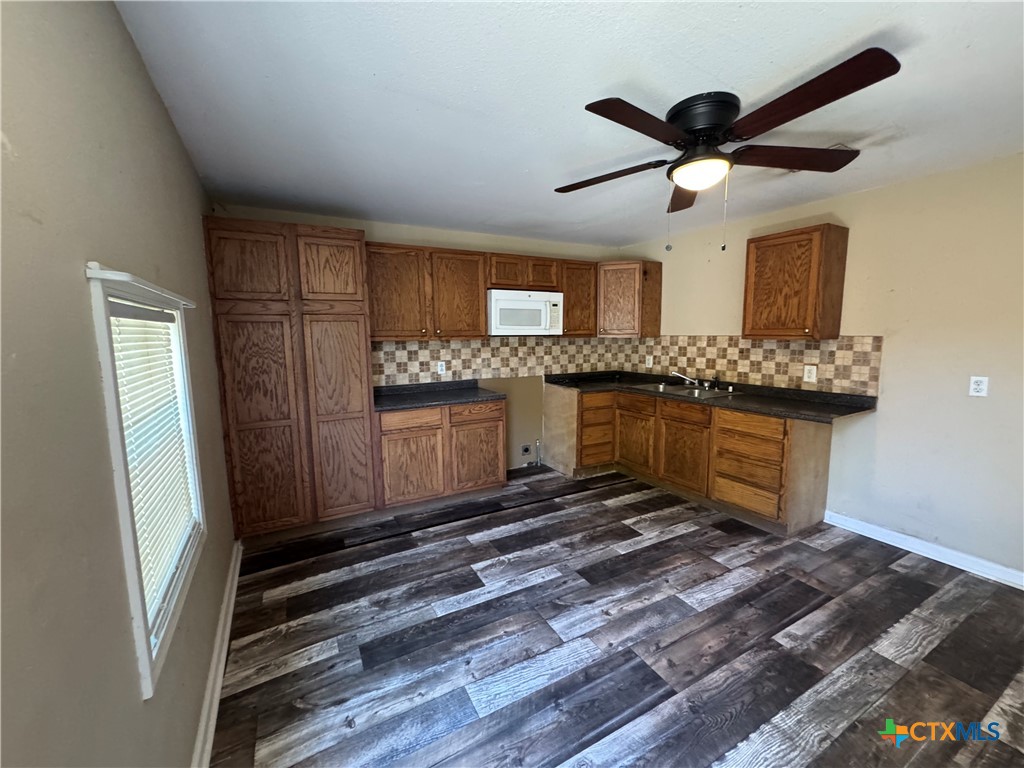 4904 Lone Tree Road Victoria, TX 77901 - Photo 3 of 13 a living room with stainless steel appliances kitchen island granite countertop furniture and a refrigerator