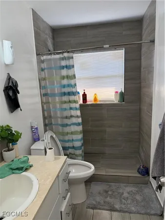 a bathroom with a sink toilet and a mirror