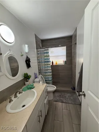 a bathroom with a sink toilet and shower