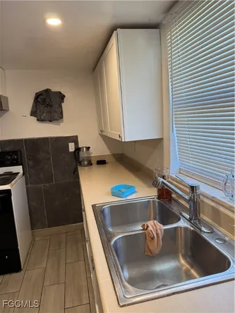 a kitchen with sink a cabinets and appliances