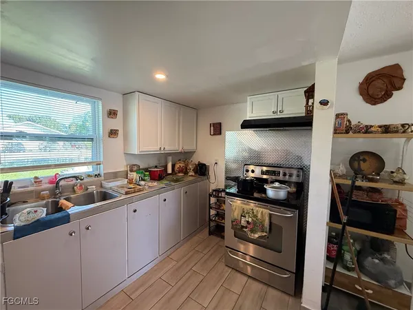 a kitchen with stainless steel appliances a refrigerator and wooden floor