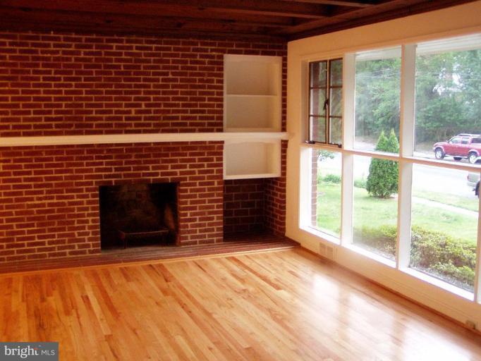 10509 Brunswick Avenue Silver Spring, MD 20902 - Photo 2 of 3 a view of empty room with wooden floor and fireplace