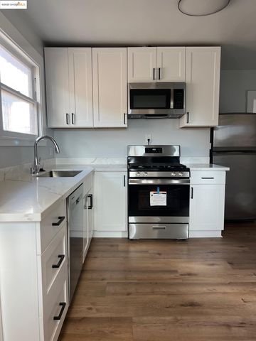 a kitchen with stainless steel appliances a stove a sink and a microwave