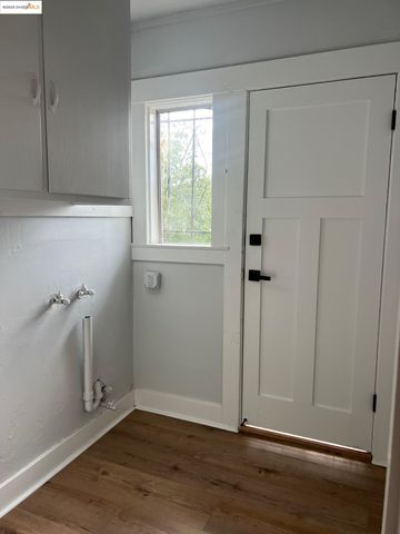 an empty room with wooden floor and a window