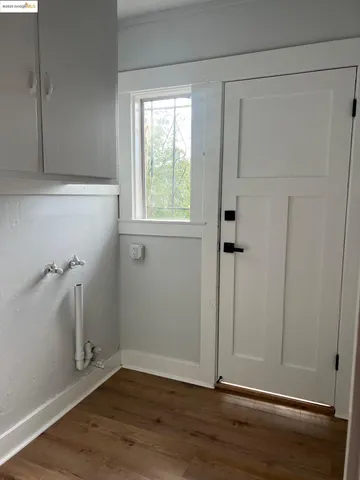 an empty room with wooden floor and a window