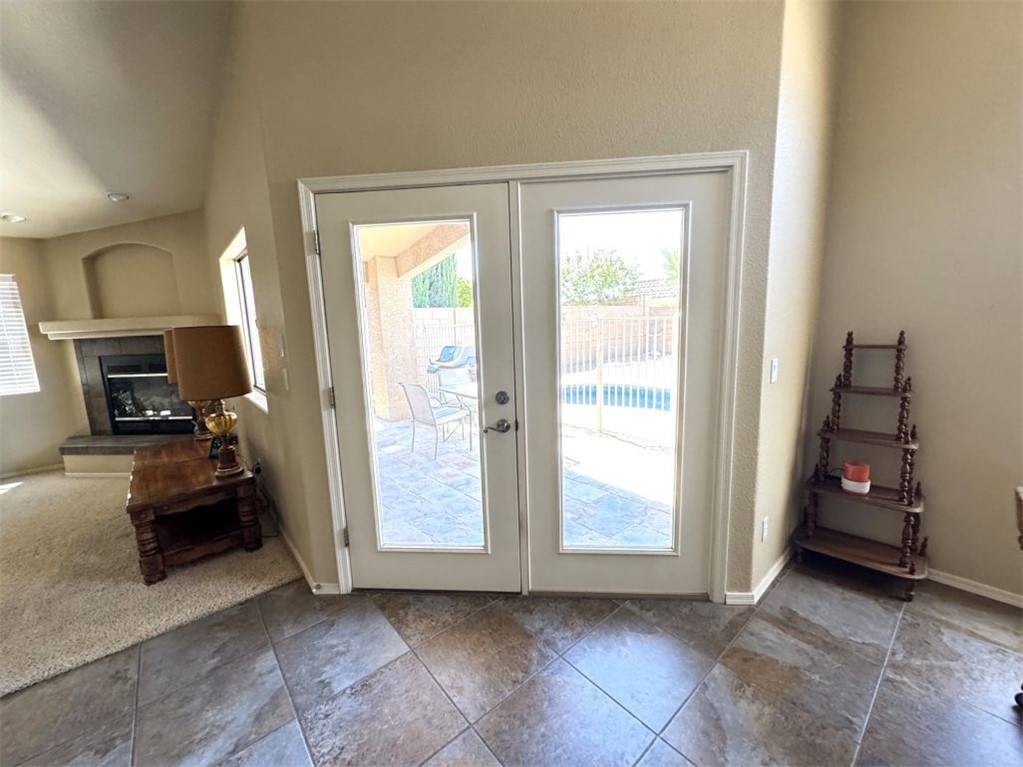 3316 Producers Mine Road Kingman, AZ 86401 - Photo 12 of 35 Double glass-paned doors opening to a tiled patio and a visible swimming pool