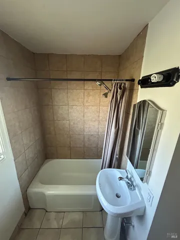 a bathroom with a sink a toilet a mirror and bathtub