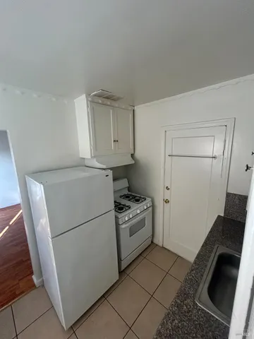 a kitchen with a refrigerator stove and cabinets