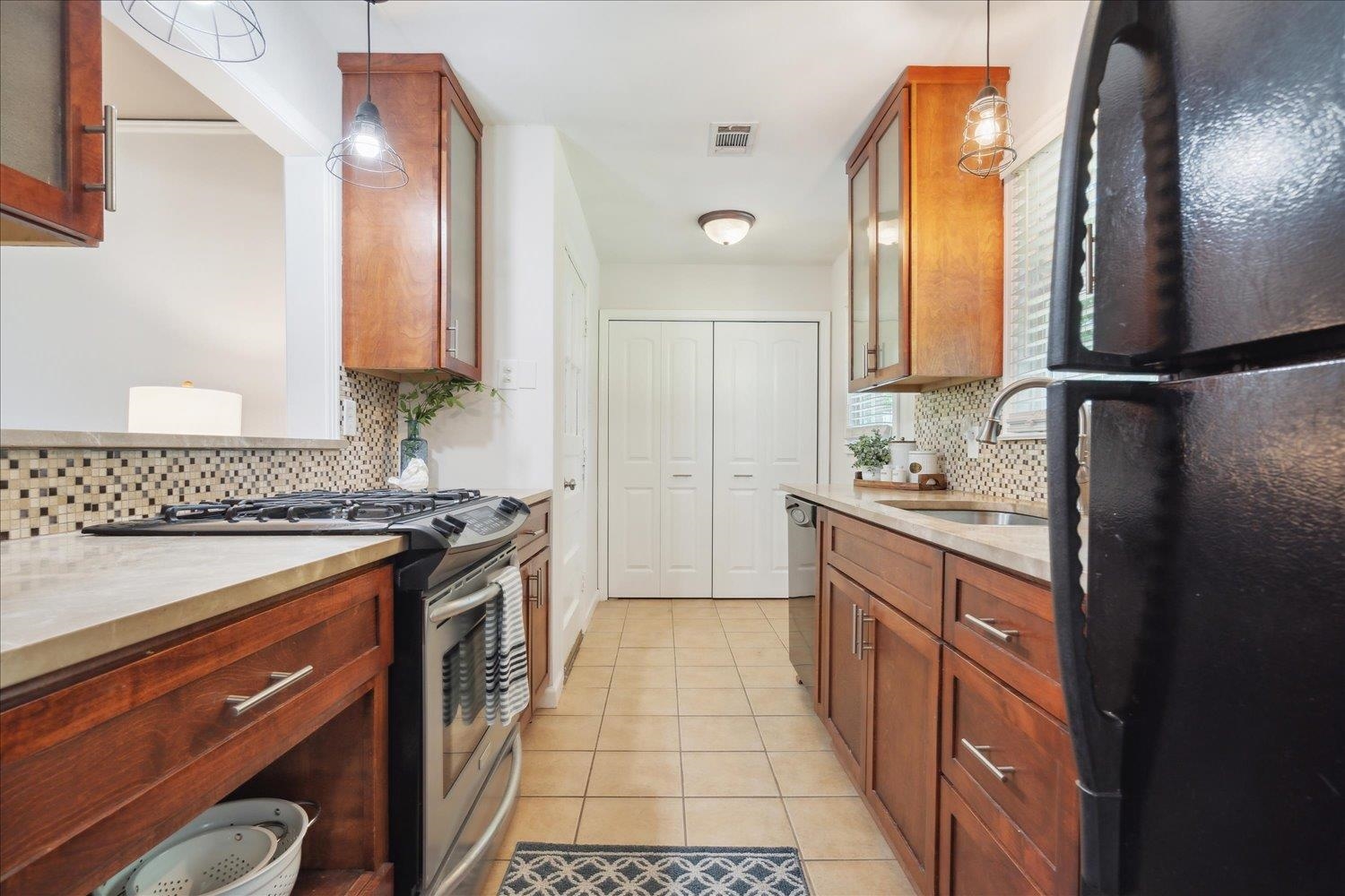5013 New Castle Road Memphis, TN 38117 - Photo 14 of 28 a kitchen with stainless steel appliances granite countertop a sink stove and refrigerator