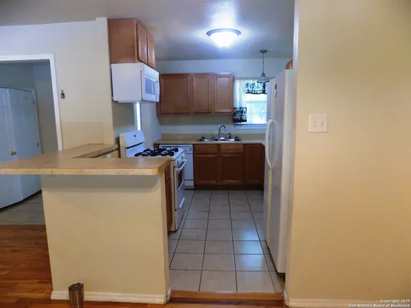a kitchen with a sink and a stove top oven