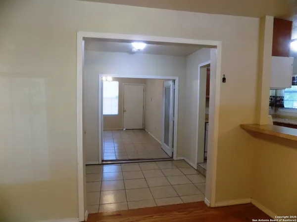 a view of a hallway with wooden floor