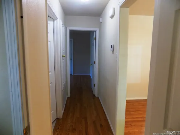 a view of a hallway with a wooden door