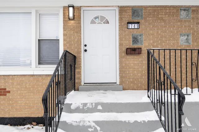 a view of an empty room with wooden floor and a ceiling fan