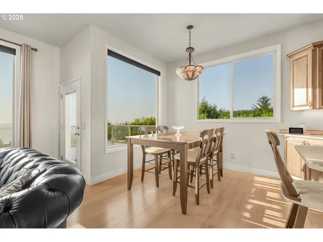 a view of a dining room with furniture and a chandelier