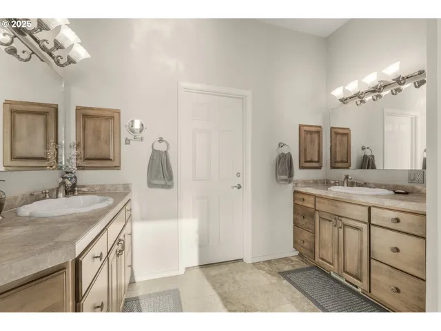 a bathroom with a sink a mirror and a shower