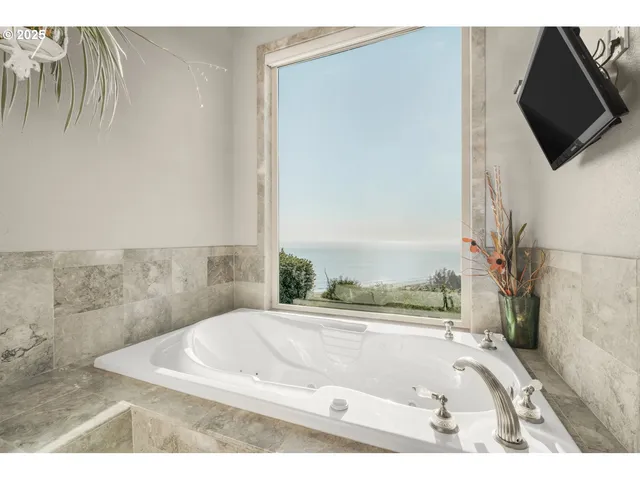 a bathroom with a bathtub and a shower