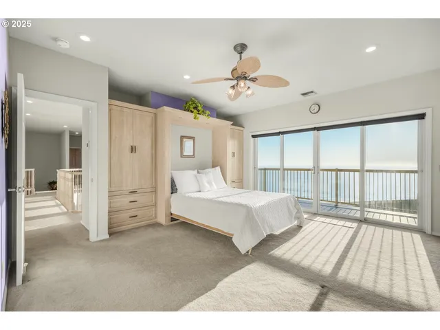 a spacious bedroom with a large bed and a chandelier