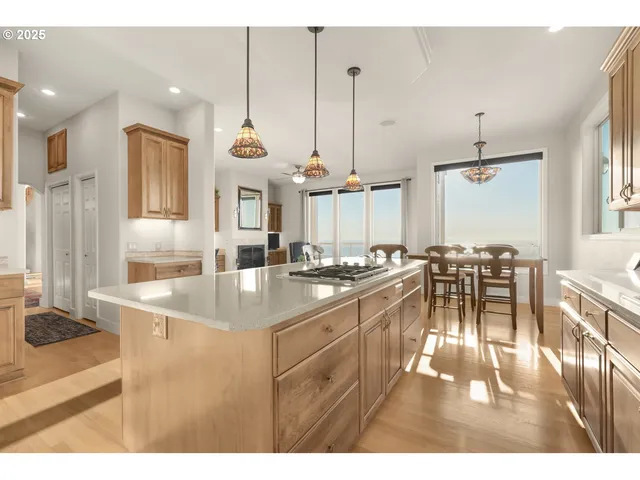 a kitchen with stainless steel appliances granite countertop a sink a stove and a refrigerator