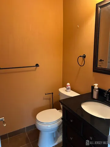 a bathroom with a sink vanity mirror and toilet